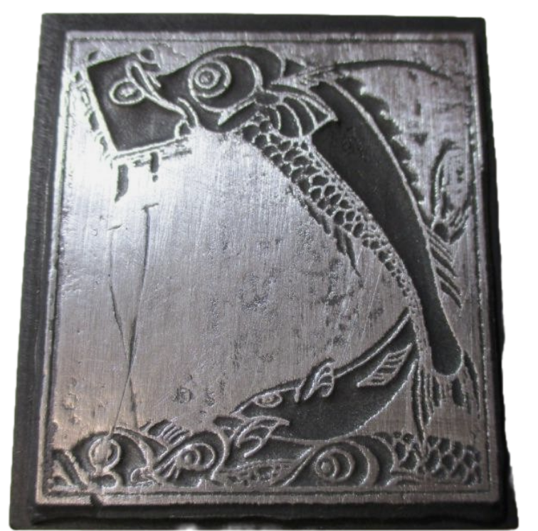 photo of letterpress block described as 'Fish swimming with book in mouth' 