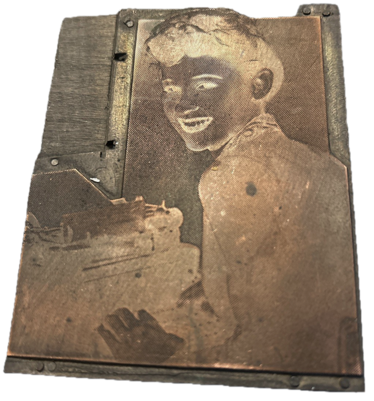 photo of letterpress block described as 'Victorian woman at typewriter looking over shoulder' 