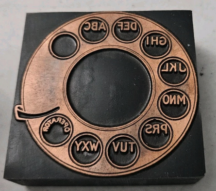 photo of letterpress block described as 'Rotary Telephone face' 